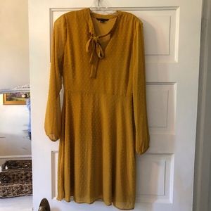 Gold colored dress with swiss-dot pattern. Size M